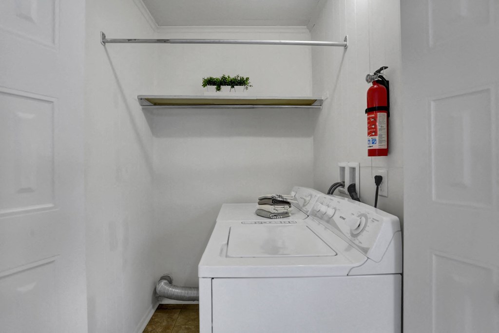 Apartments in Williamsport | Woodland Park |a small laundry room with a white washer and dryer