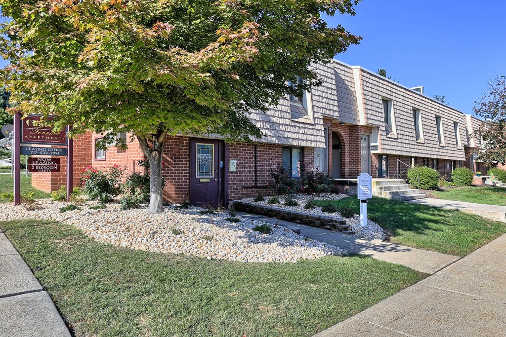 A brick building with a tree in front of it.