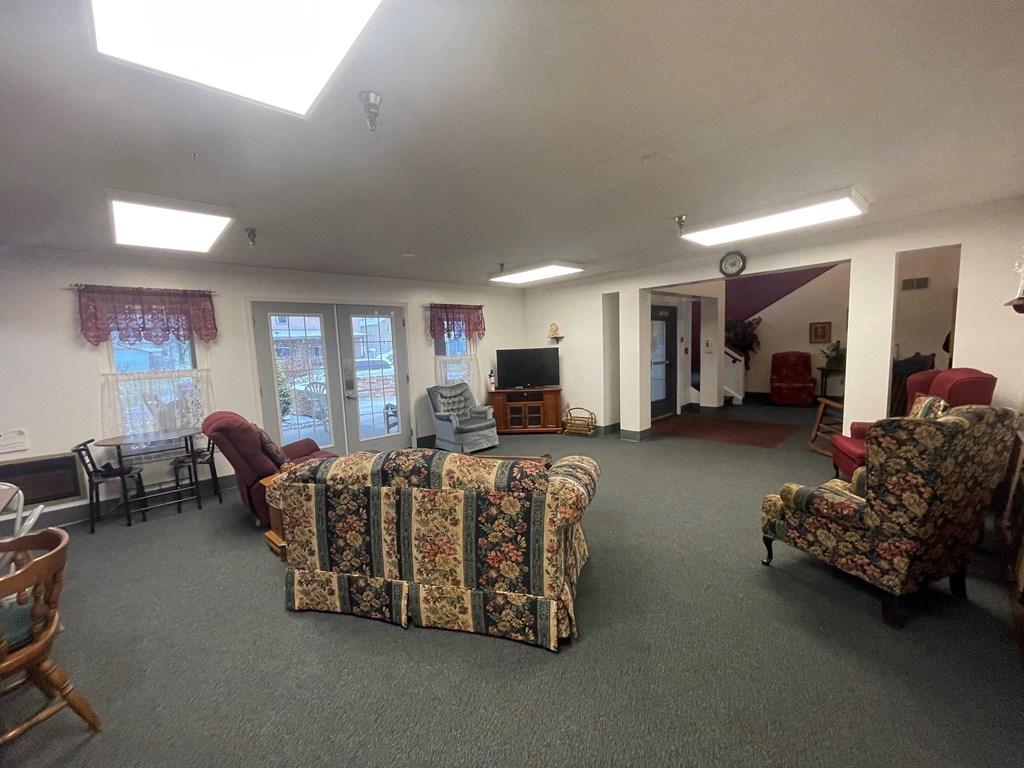a large living room with couches and chairs
