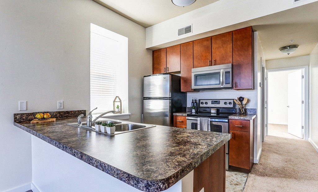 a kitchen with stainless steel appliances and granite counter tops