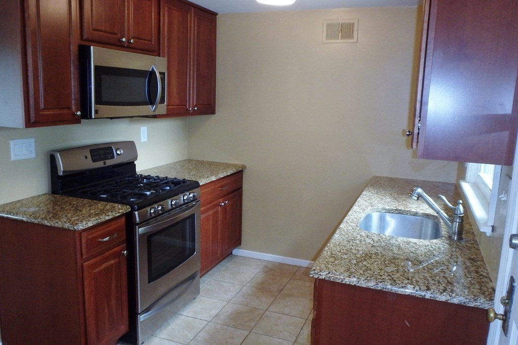 a kitchen with granite counter tops and stainless steel appliances
