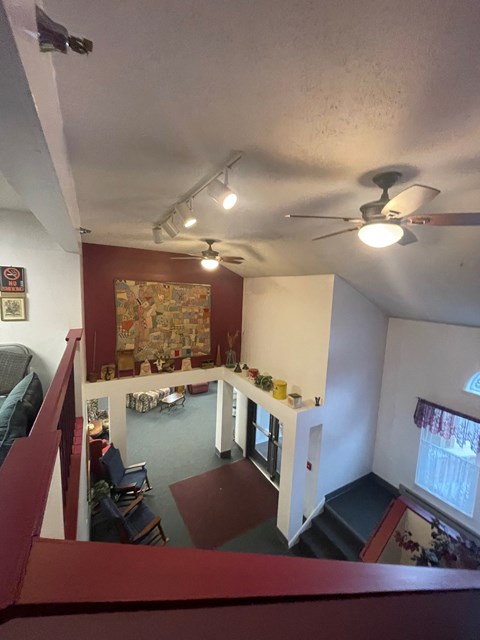 A view of a living room from the top of the stairs