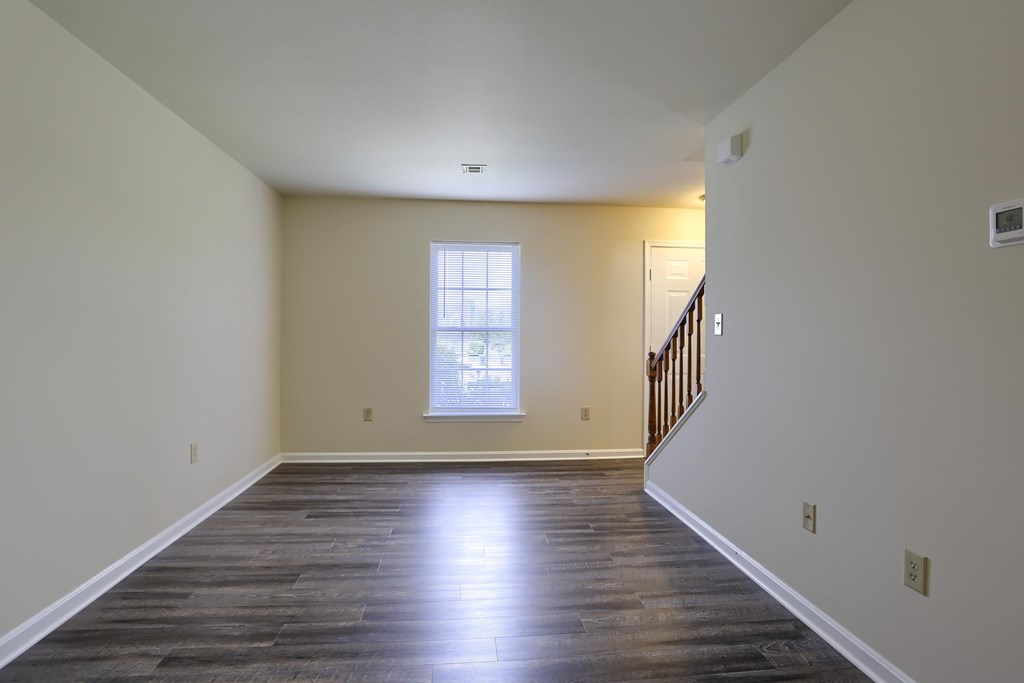 A room with wooden floors and a window.