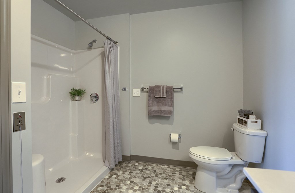Mount Joy Senior Housing | a bathroom with a shower toilet and sink