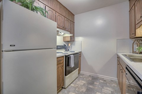 a kitchen with white appliances and wooden cabinets
