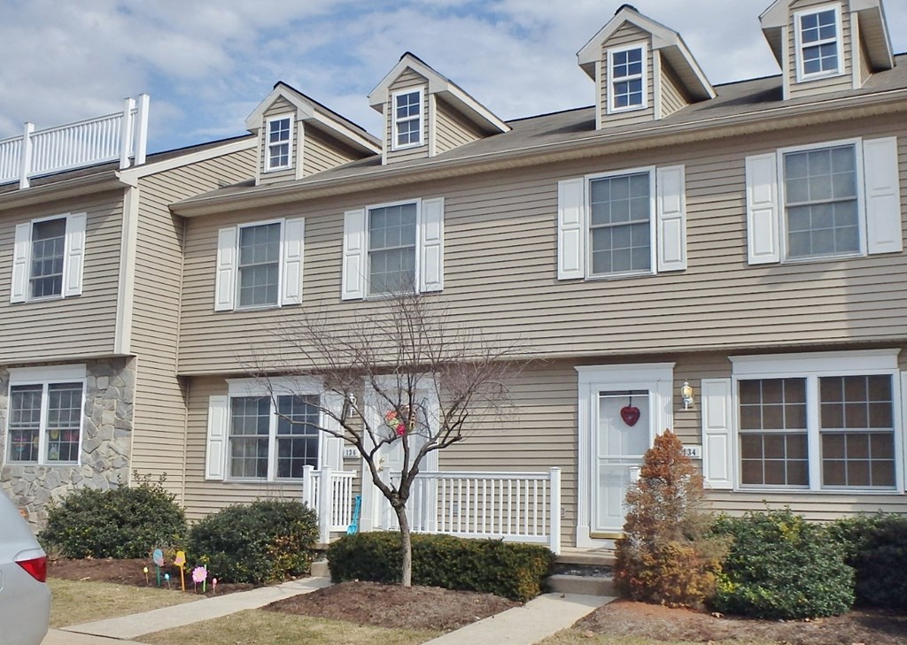 the front of a house with a christmas tree in the front yard