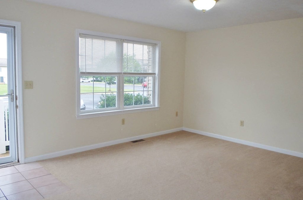 an empty living room with a large window