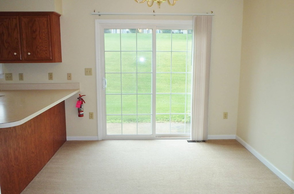 an empty living room with a sliding glass door