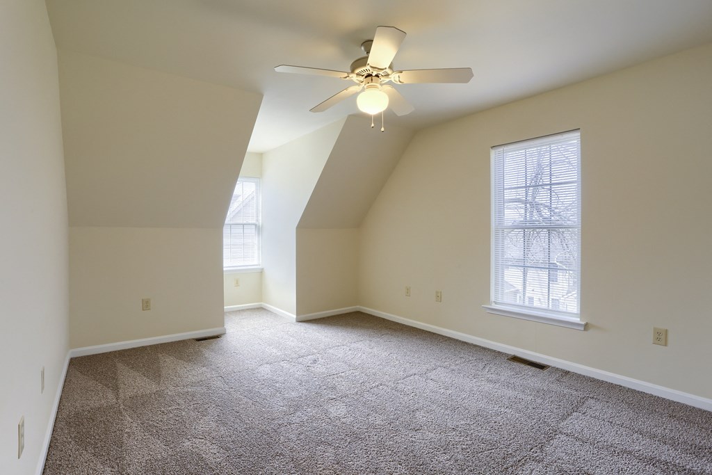 Mechanicsburg Apartments | Rockledge Townhomes |an empty bedroom with a ceiling fan and two windows