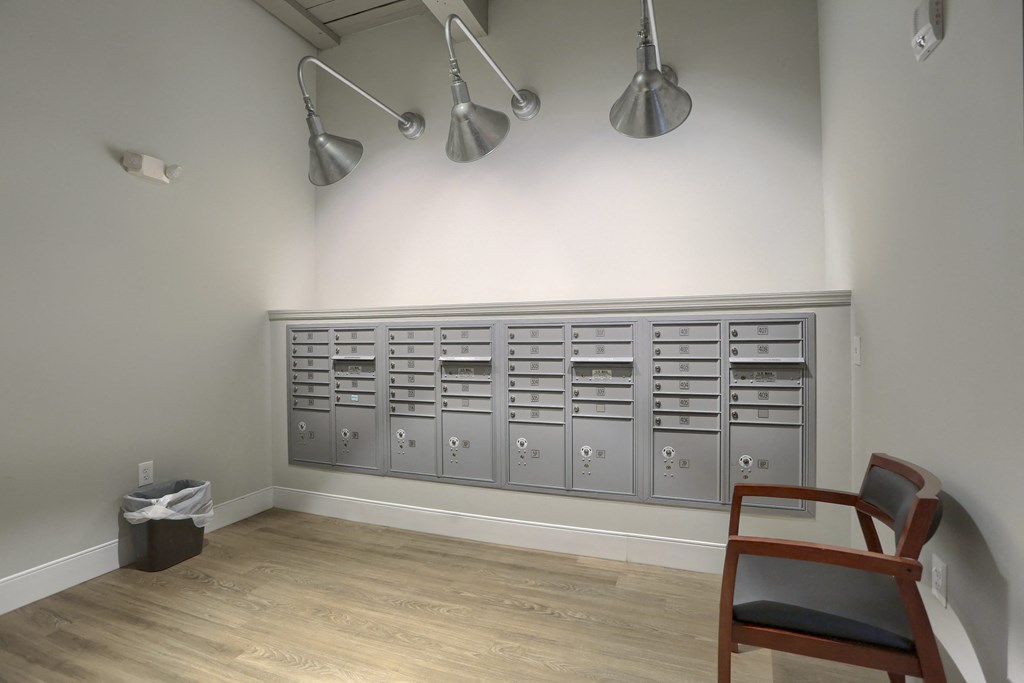 Mount Joy Senior Housing | a row of gray metal cabinets and a chair in a room with a hardwood floor