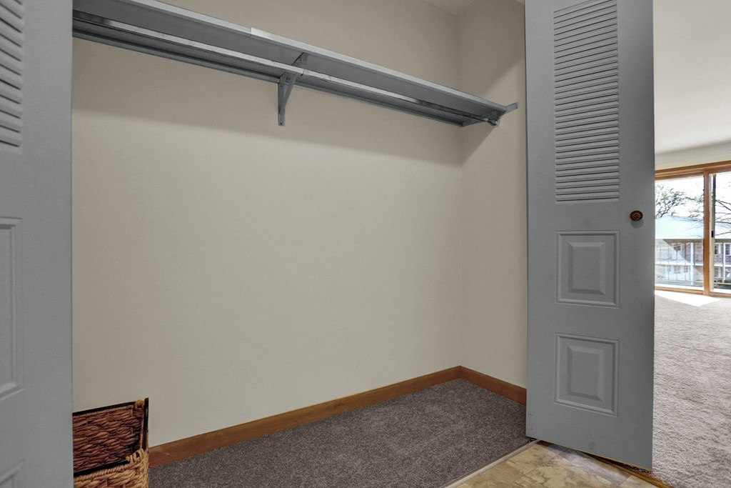 an empty room with a door and a window