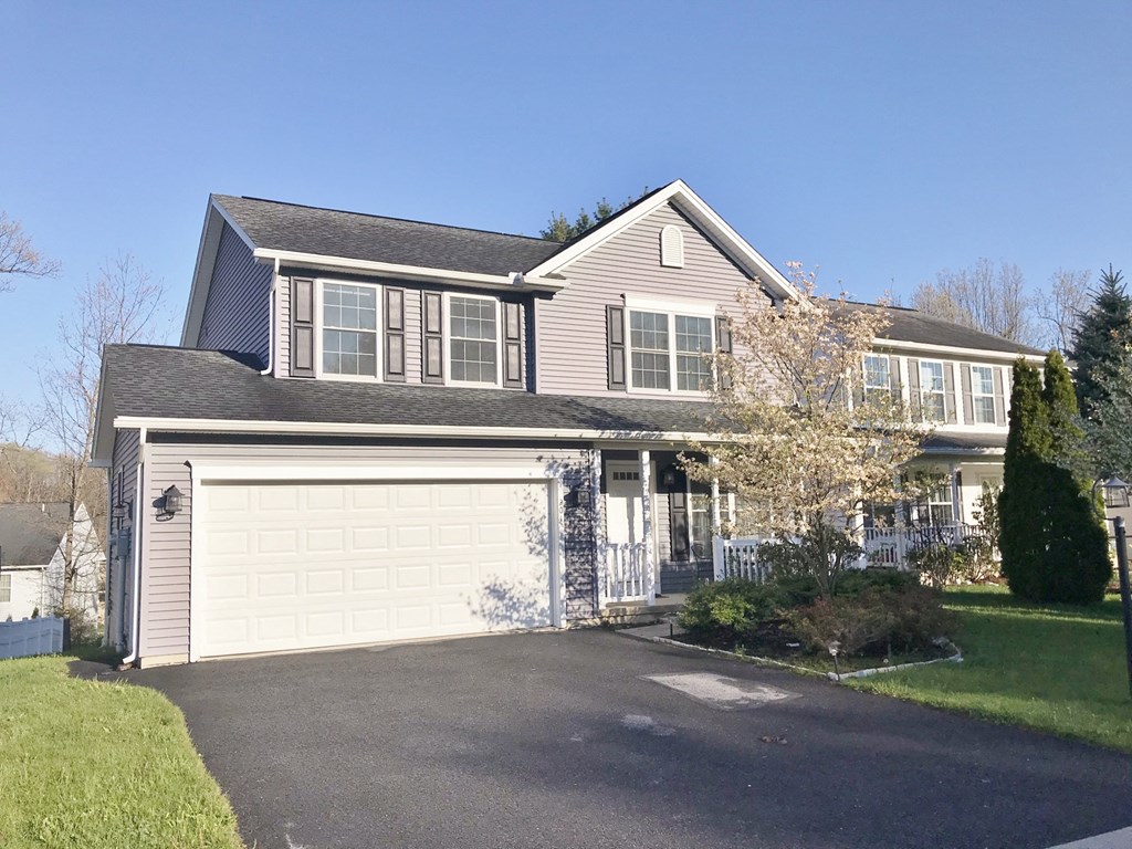 a large house with a white garage door