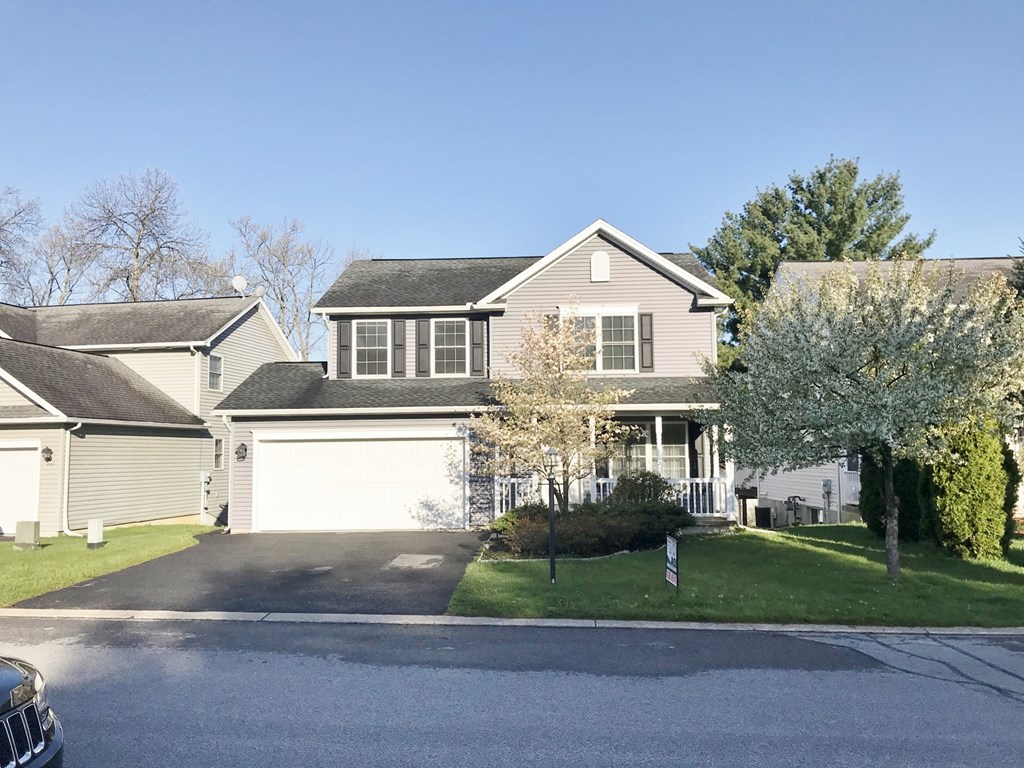 the front of a house with a garage and a driveway
