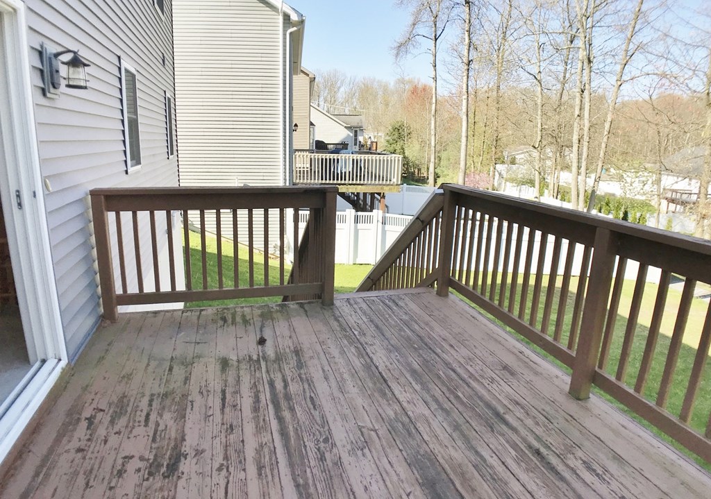 the deck has a view of the yard and the house