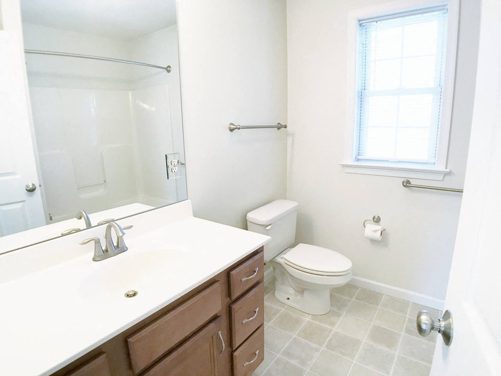 a bathroom with a toilet and a sink and a mirror