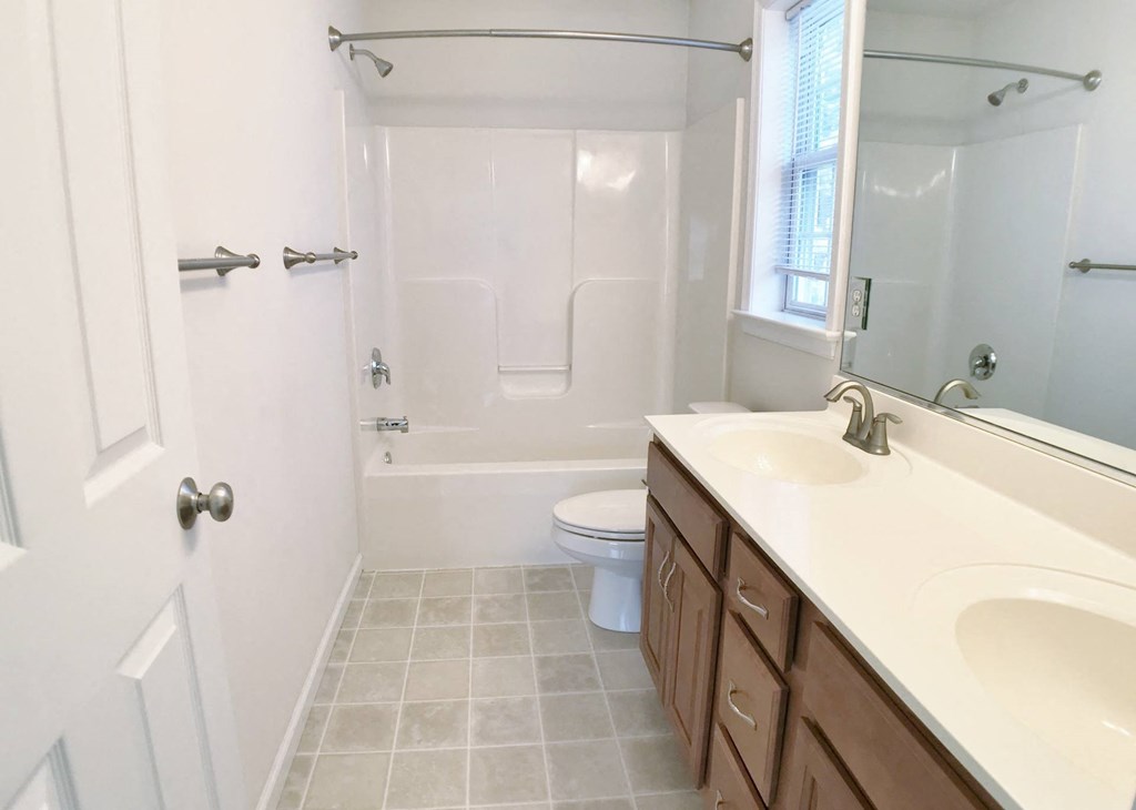 a bathroom with a sink and a toilet and a shower