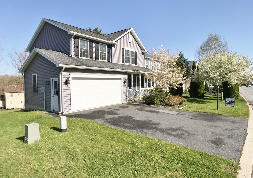 a house with a white garage door and a lawn