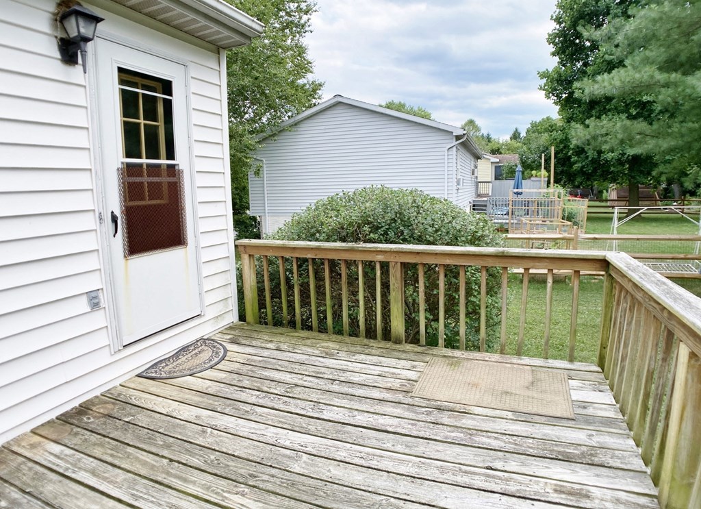 the deck has a door to the backyard