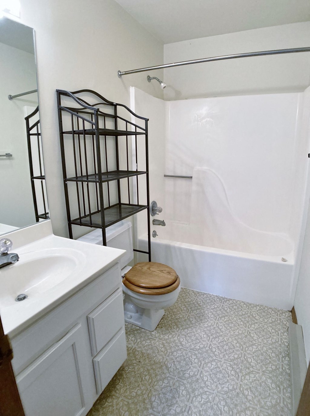 a bathroom with a toilet and a sink and a shower