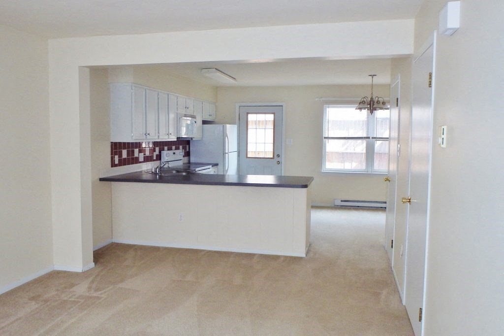 an empty kitchen with an island in the middle of it