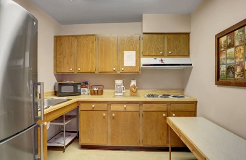 a kitchen with wooden cabinets and stainless steel appliances