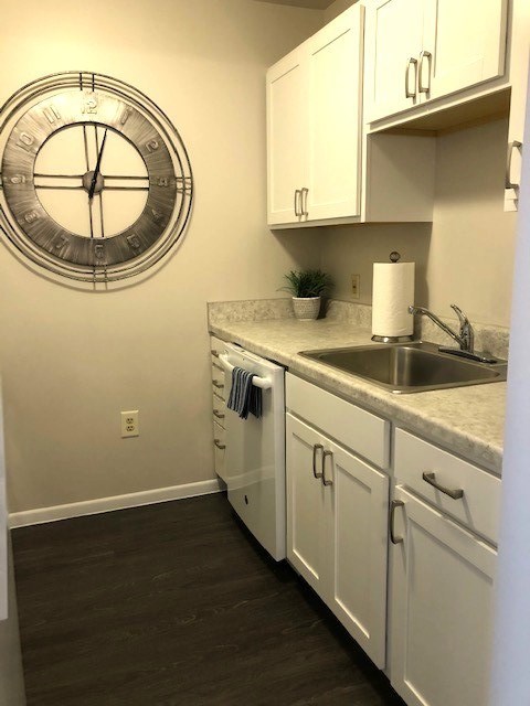 A kitchen with a clock on the wall.