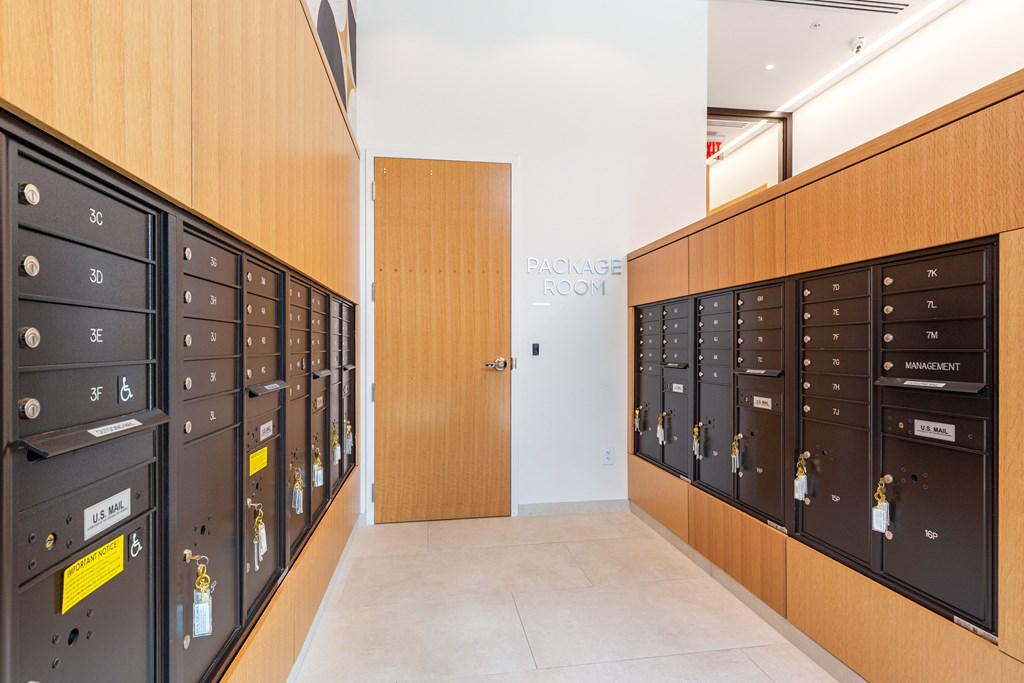 A hallway with a row of lockers on the left and right.