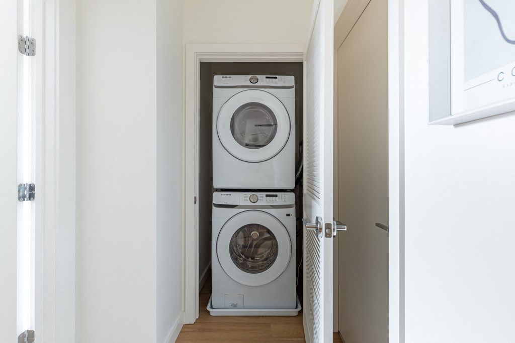 A white washing machine and dryer in a small laundry room.