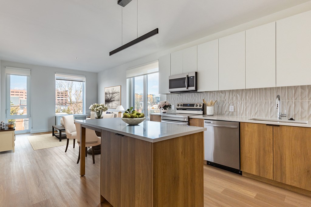 A modern kitchen with wooden cabinets and a large island.
