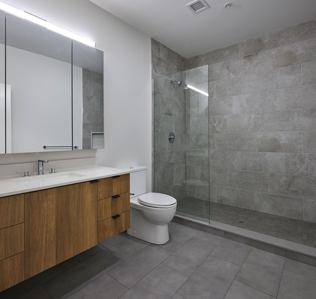 a bathroom with a toilet and a sink and a shower