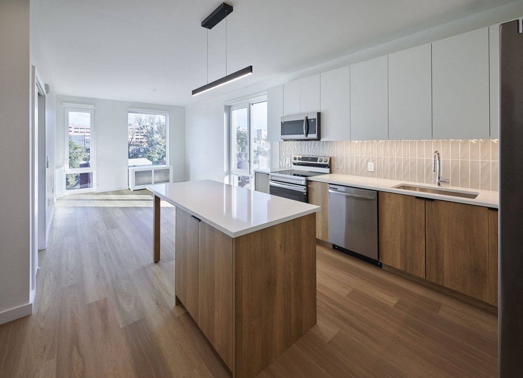 a large kitchen with an island in the middle of it