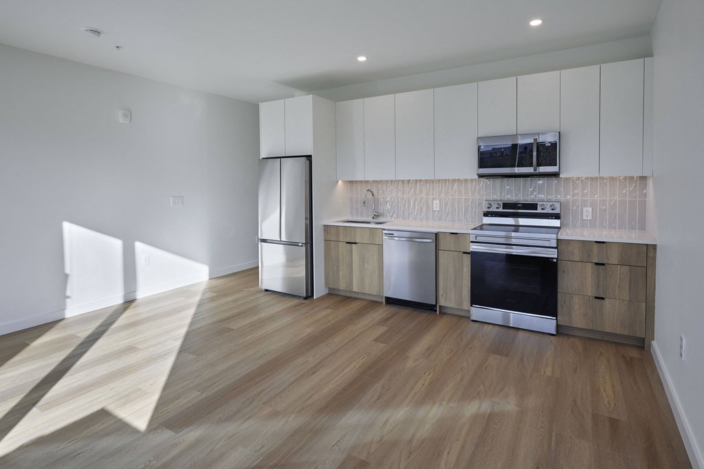 a kitchen with white cabinets and stainless steel appliances