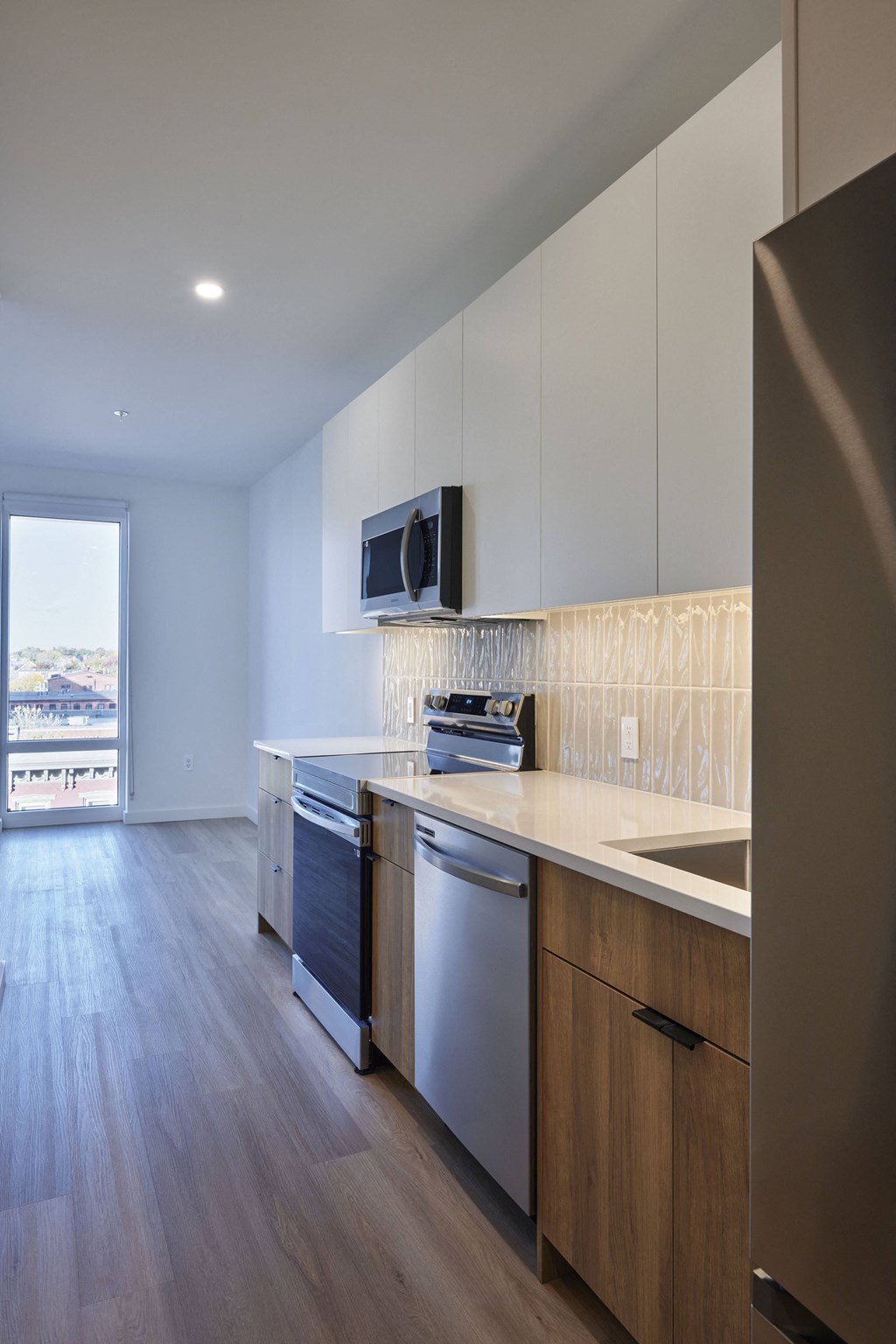 a kitchen with white cabinets and stainless steel appliances