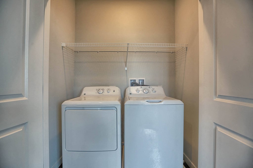 a washer and dryer in a laundry room with white doors