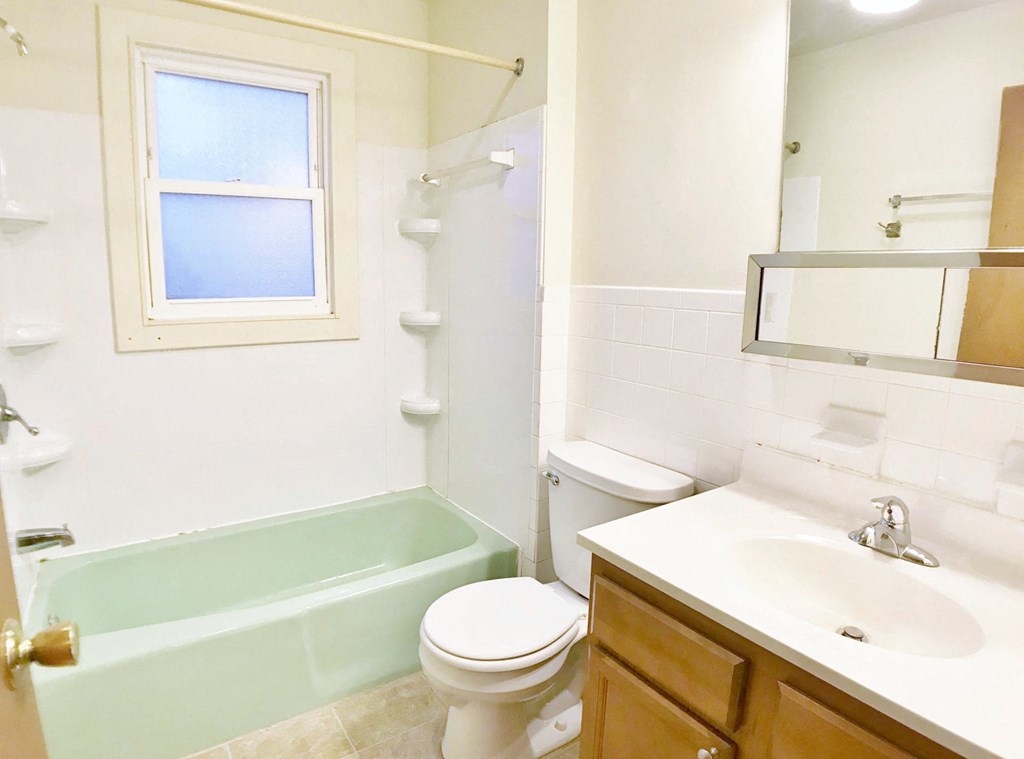 a bathroom with a sink toilet and a tub
