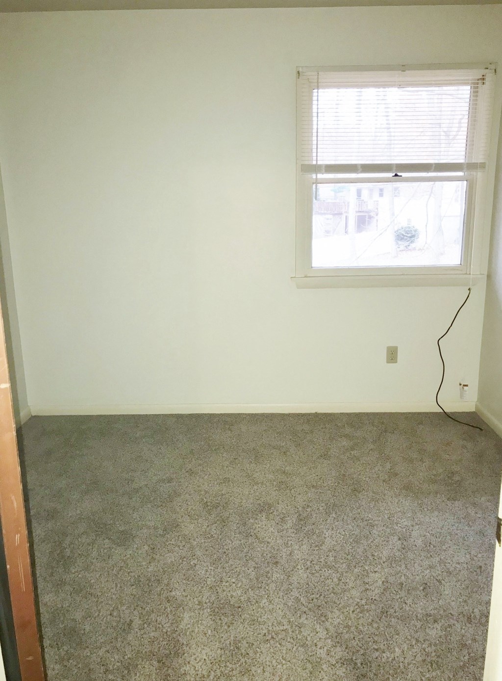 a room with a carpeted floor and a window