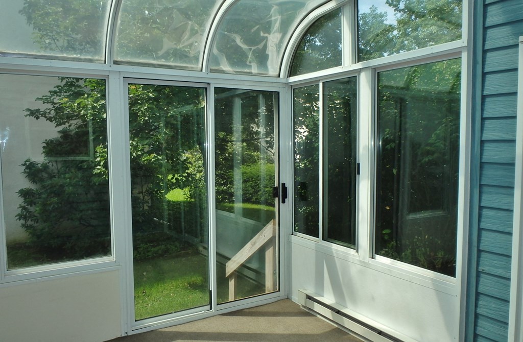 a conservatory with glass doors and windows
