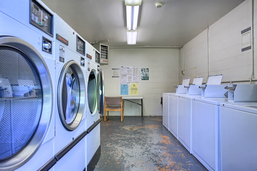 a washer and dryer in a laundry room with other washing machines