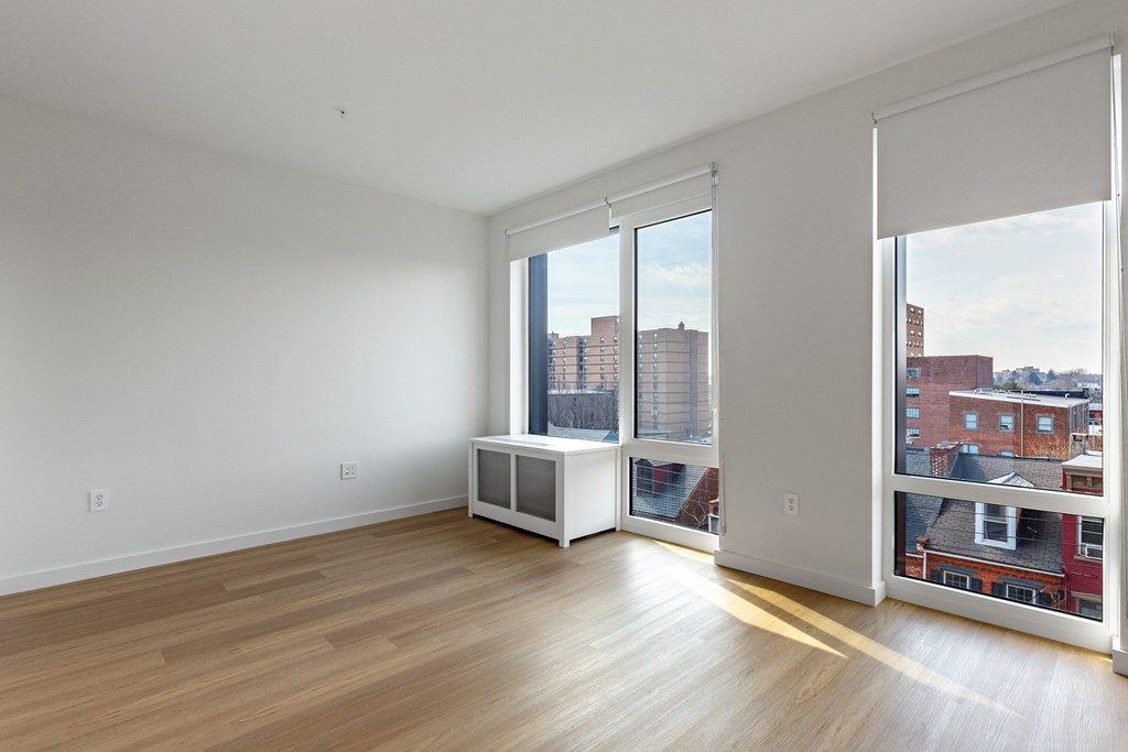 A room with a window overlooking a cityscape.
