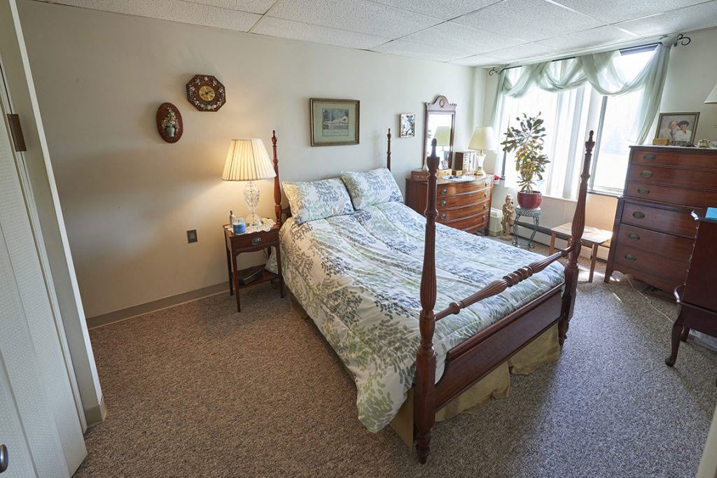 a bedroom with a bed and a dresser