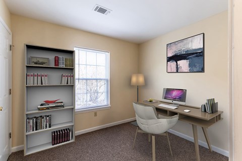 A room with a desk, chair, and bookshelf.