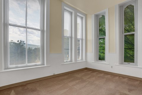 the living room of a house with four windows