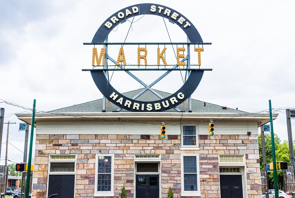 the sign for broad street market on top of a brick building