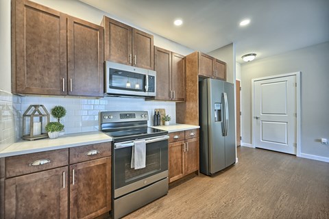 a kitchen with stainless steel appliances and wooden cabinets