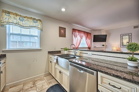 the kitchen has granite counter tops and stainless steel appliances