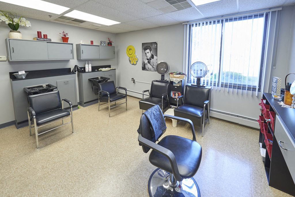 a waiting room with chairs and a counter in a hospital