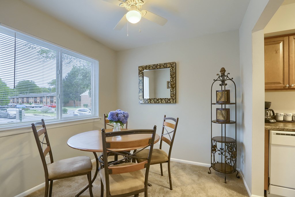Mechanicsburg Rentals Delbrook Manor Mechanicsburg Apartments | Delbrook Manor Apartments | a dining room with a large window and a ceiling fan