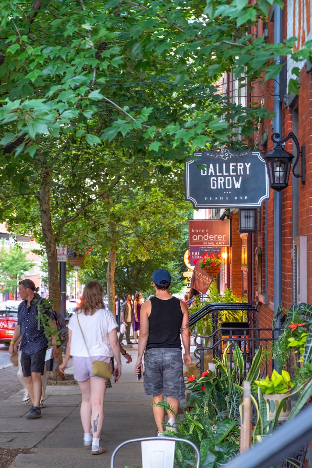 people walking down a sidewalk on a city street