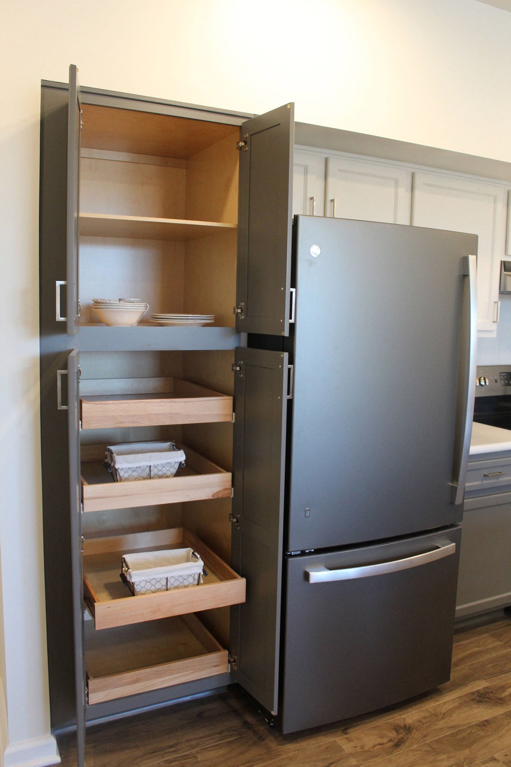 a black refrigerator freezer sitting inside of a kitchen