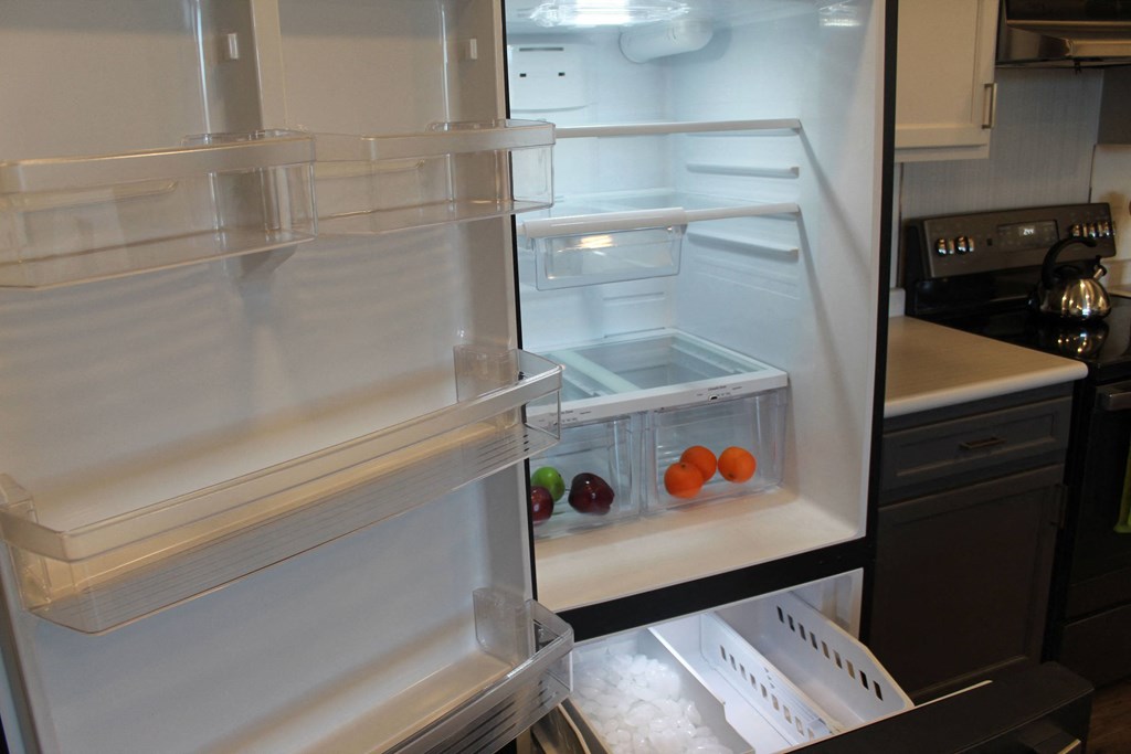 an empty refrigerator with fruits and vegetables in it